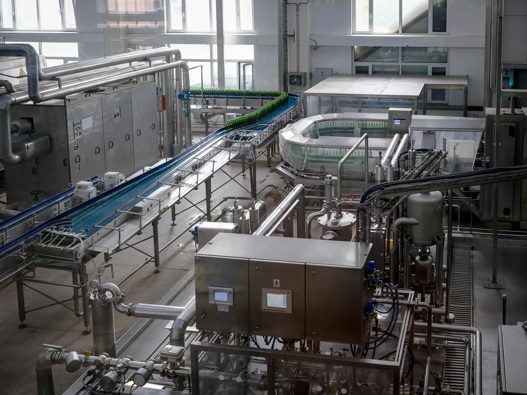 Food processing plant with stainless equipment, process piping and conveyor line